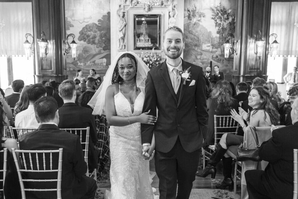 bride and groom walking down aisle after kiss