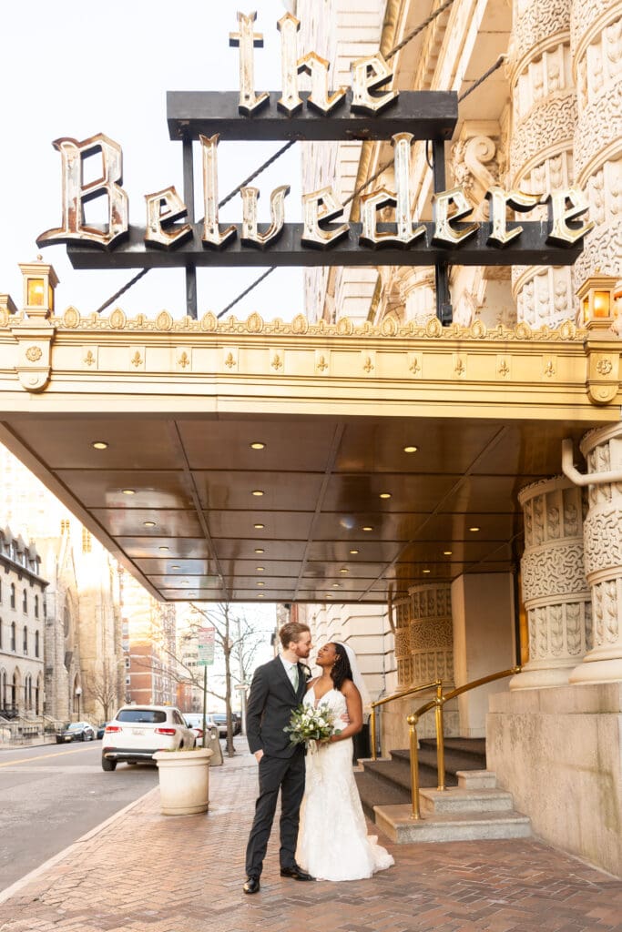bride and groom smiling under the belvedere sign