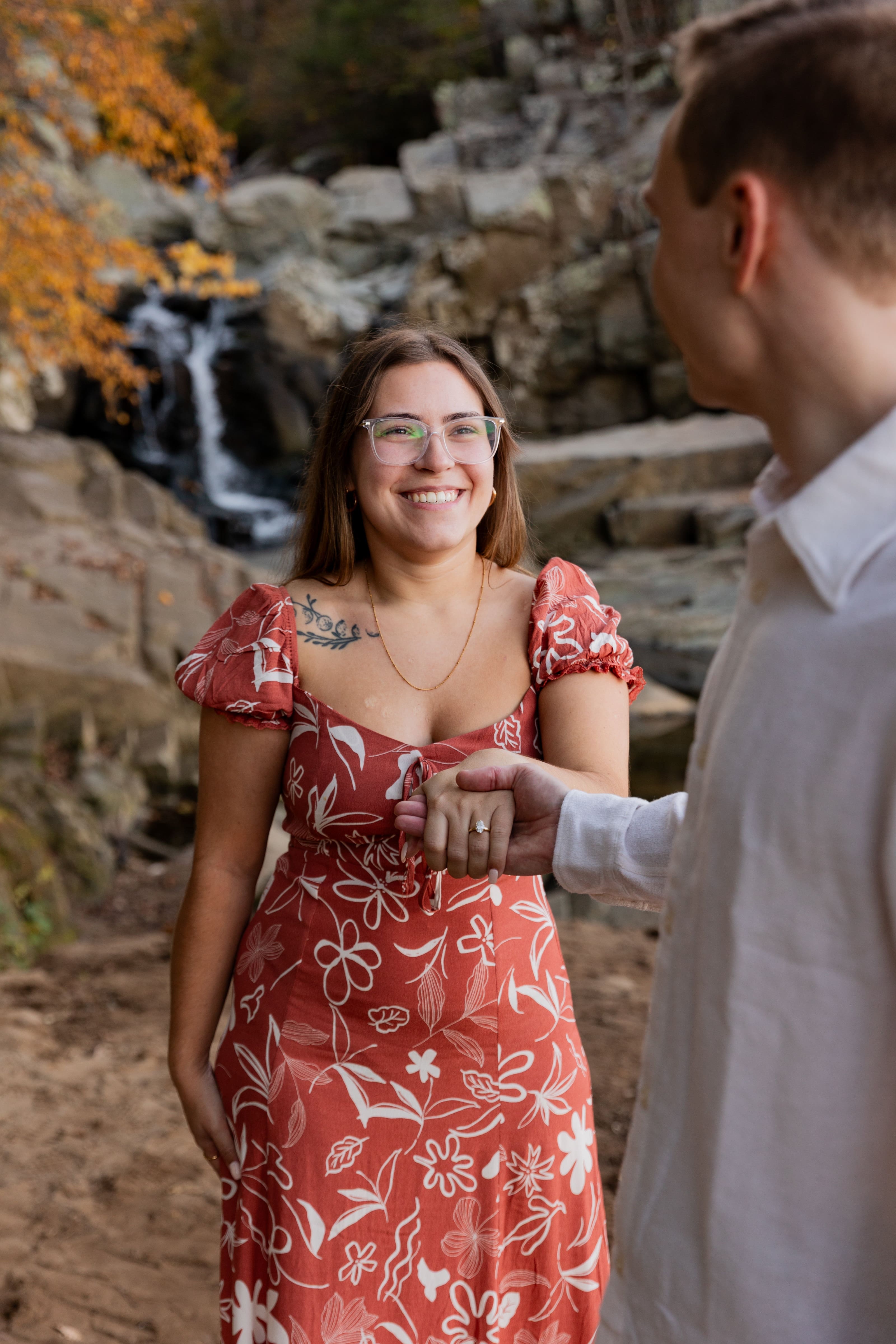 Couple smiling waterfall in background