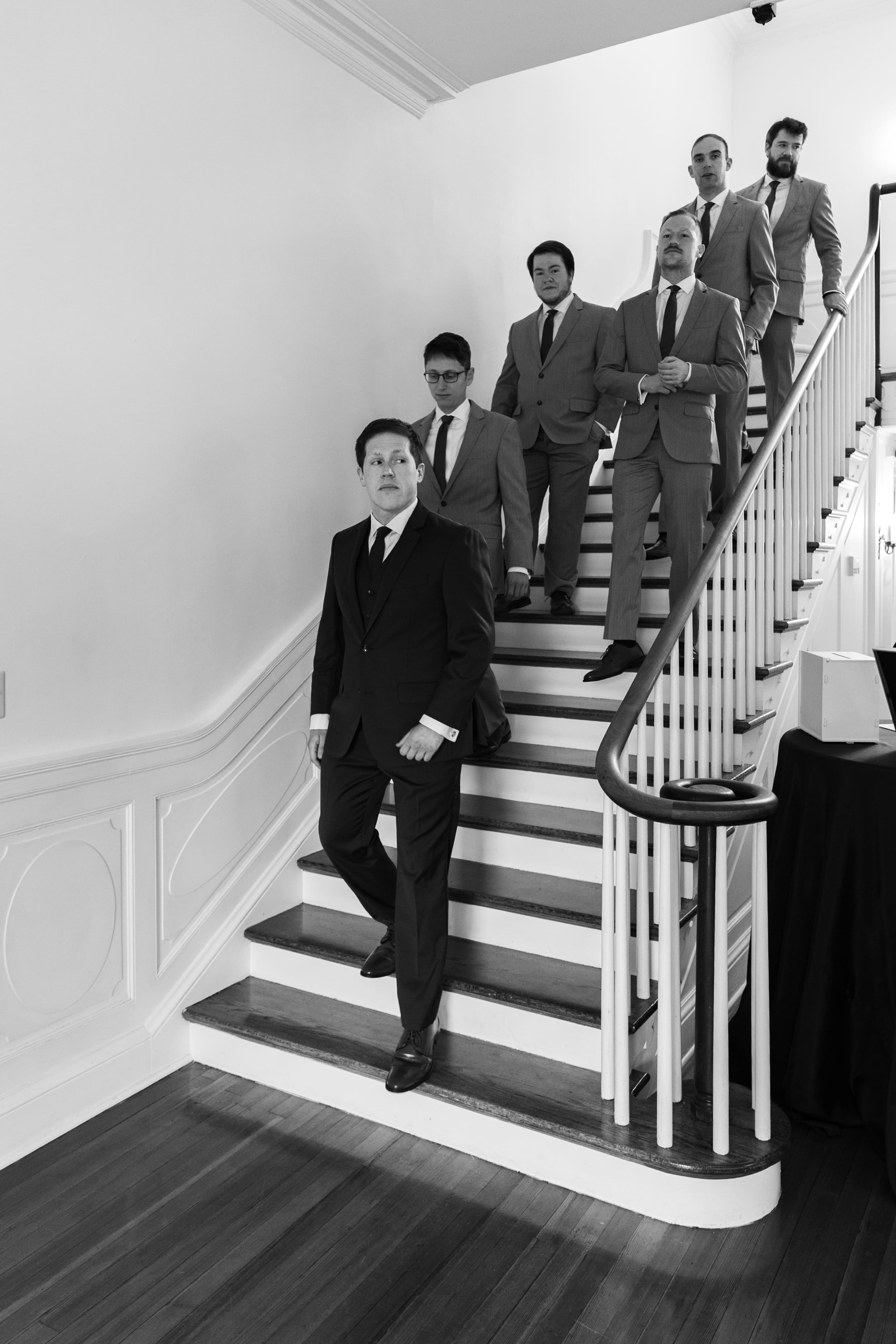 groomsmen walking down stairs before ceremony