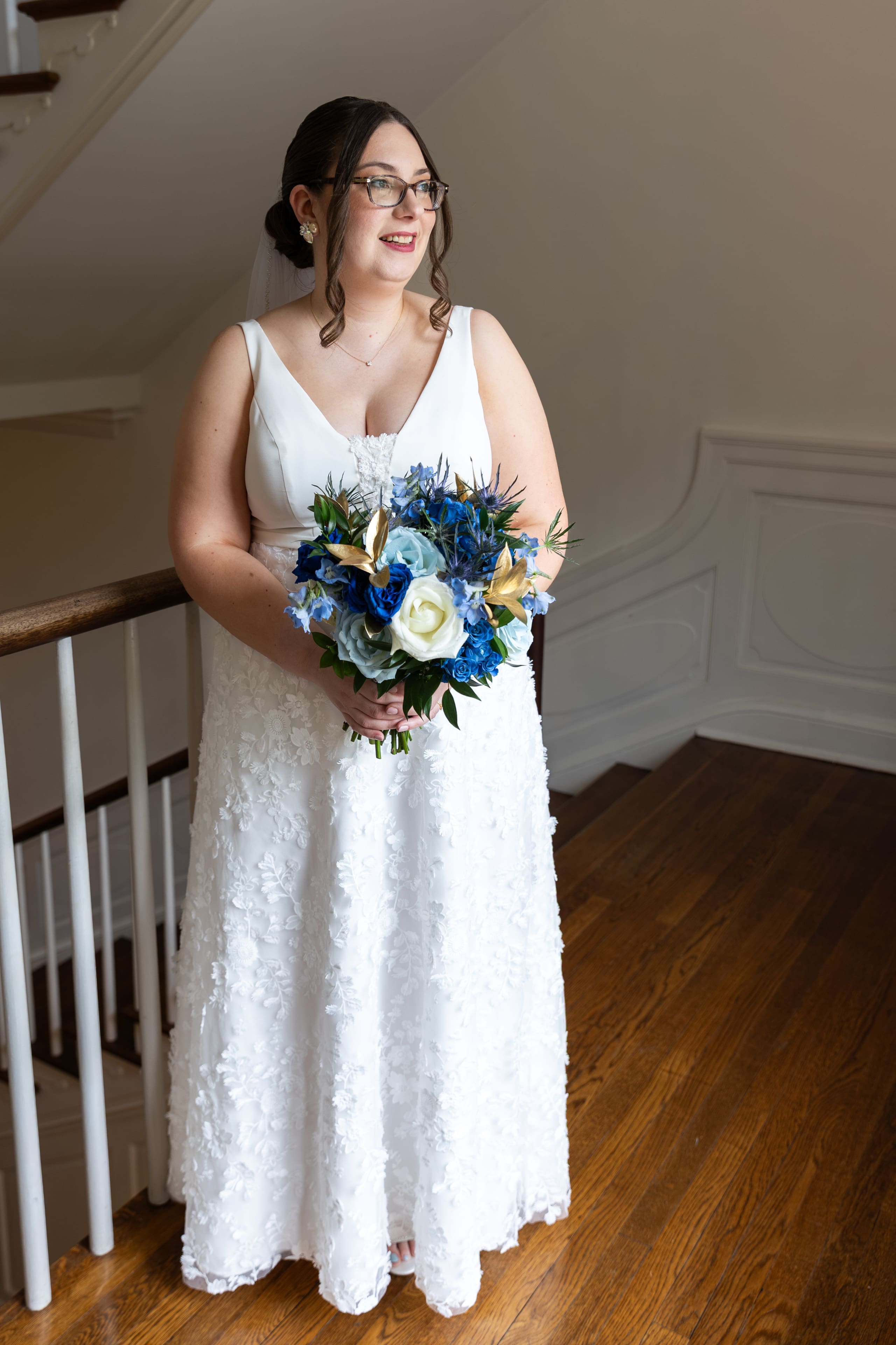 bride by herself looking out window of rust manor