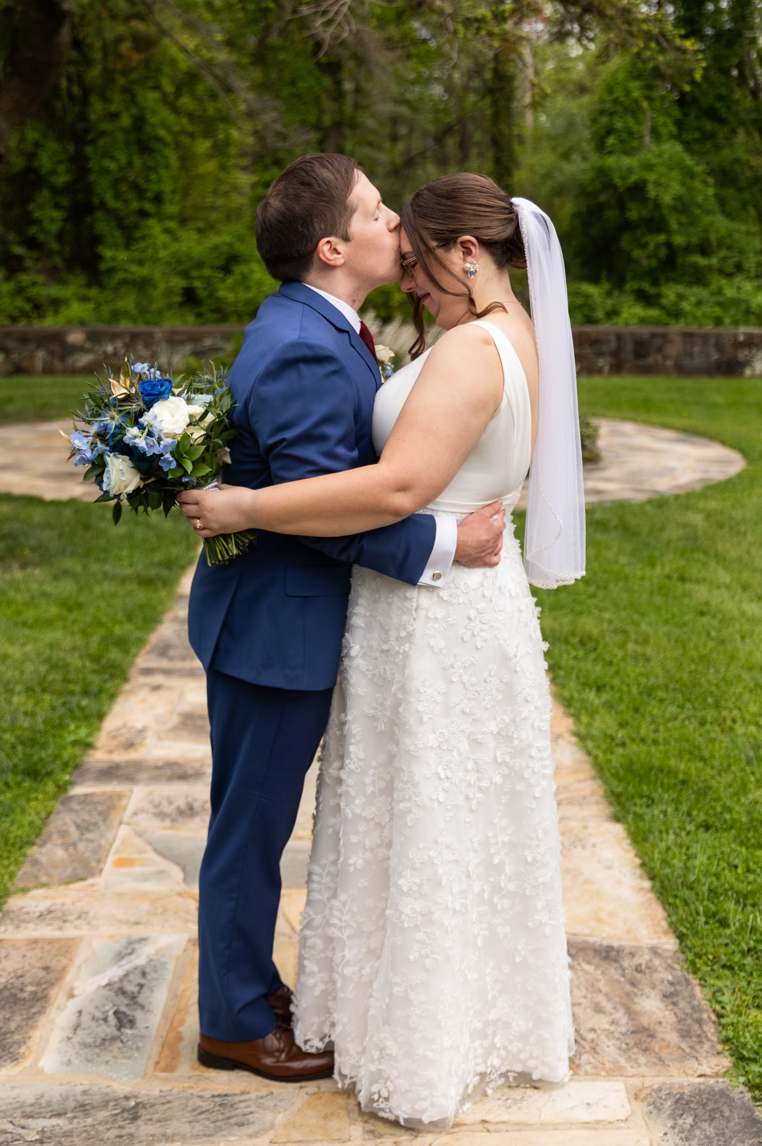 groom kissing brides forehead